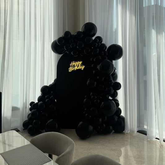 All-Black Matte Arch with Glossy Balloon Garland & Neon Sign