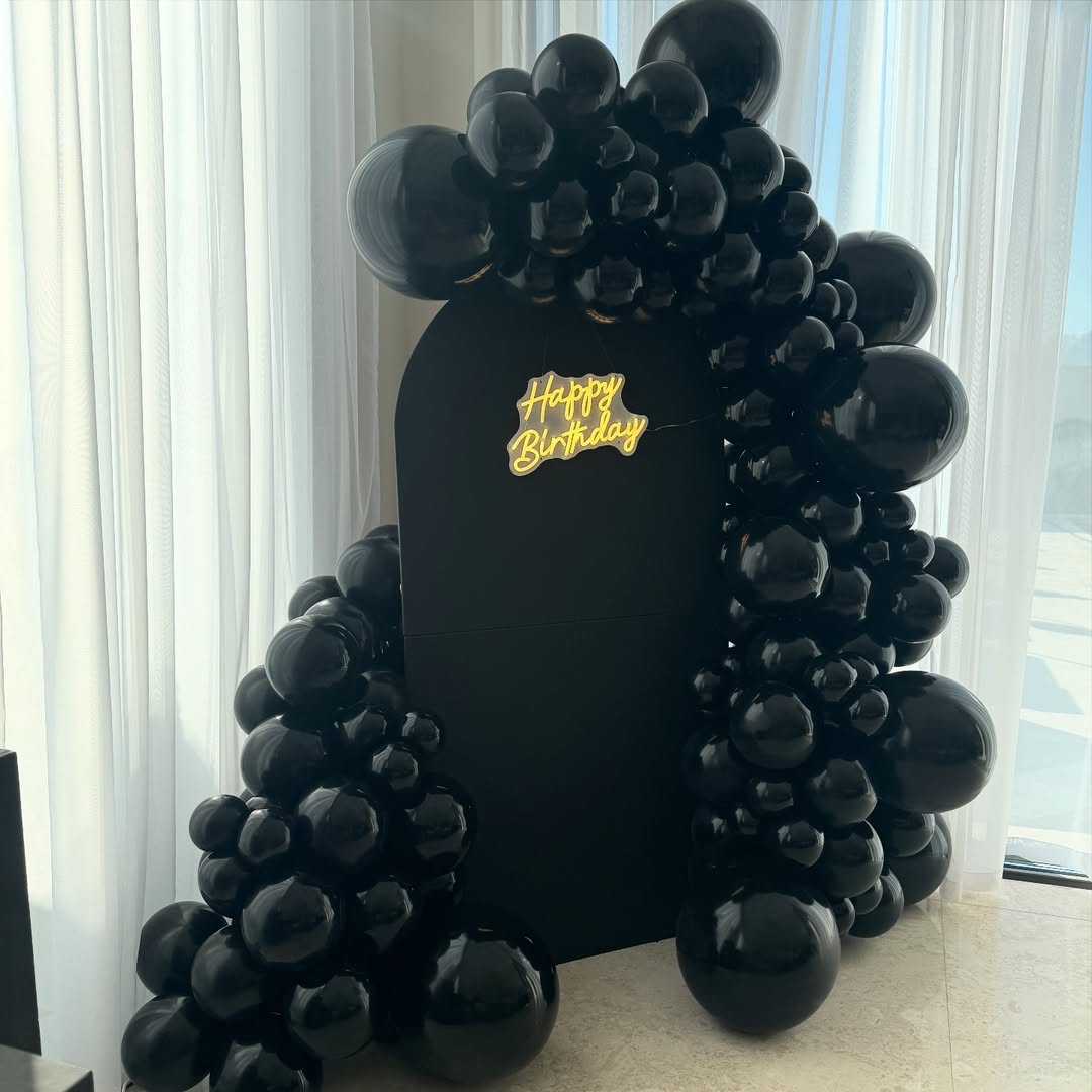 All-Black Matte Arch with Glossy Balloon Garland & Neon Sign