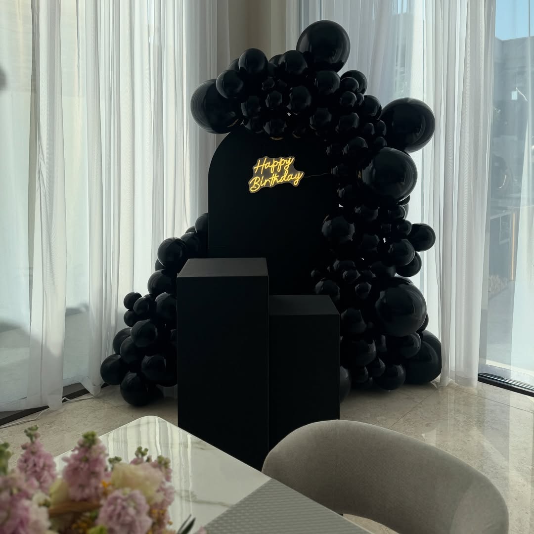 All-Black Matte Arch with Glossy Balloon Garland & Neon Sign